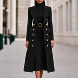 Black double-breasted long coat worn over matching belted knit midi dress