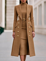 Double-breasted long coat worn over matching belted knit midi dress