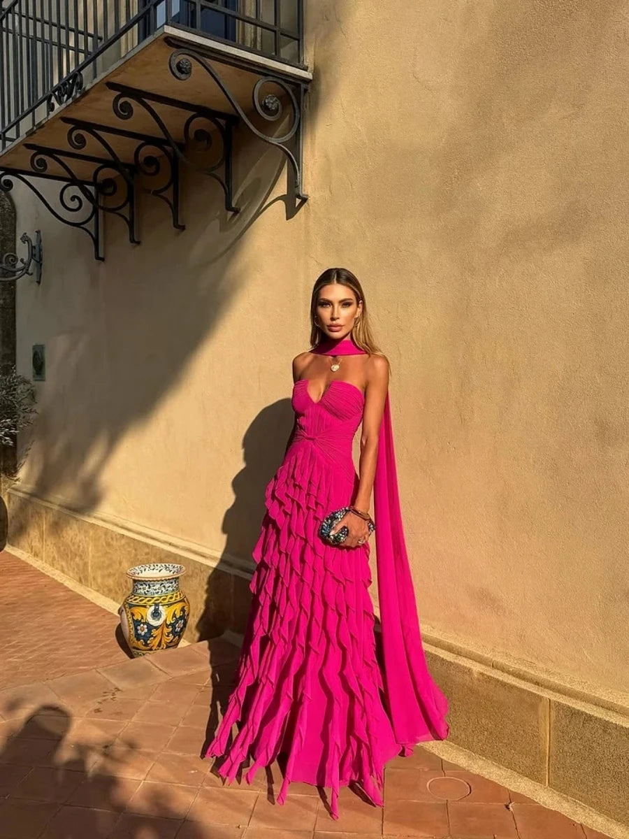 Model wearing a tiered ruffle chiffon halter ball gown with sweetheart neckline and long train
