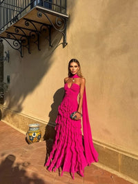Model wearing a tiered ruffle chiffon halter ball gown with sweetheart neckline and long train