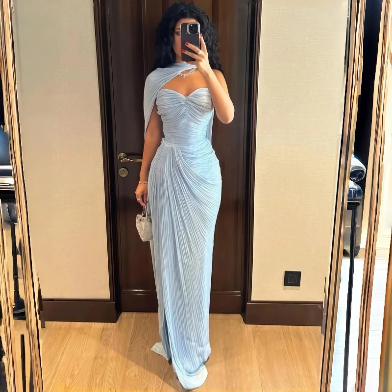 Model wearing a shiny satin mermaid evening gown with sweetheart neckline and ruffle hem