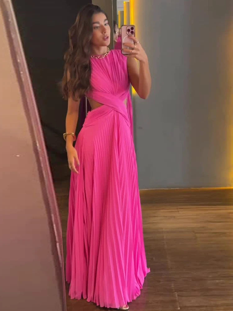 Back view of the pleated cut-out maxi dress showing the fully open back