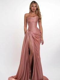 Dusty pink chiffon mermaid gown shown from the side with ruched bodice