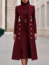 Double-breasted long coat worn over matching belted knit midi dress