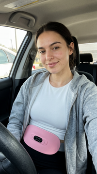 Cordless period relief belt worn under hoodie while driving