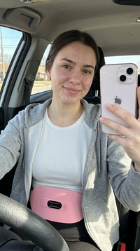 Wearing the Enigmae Ease belt in the car - portable cramp relief on the go
