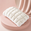 MarshmallowBreeze white puff pillow on a soft pink studio background